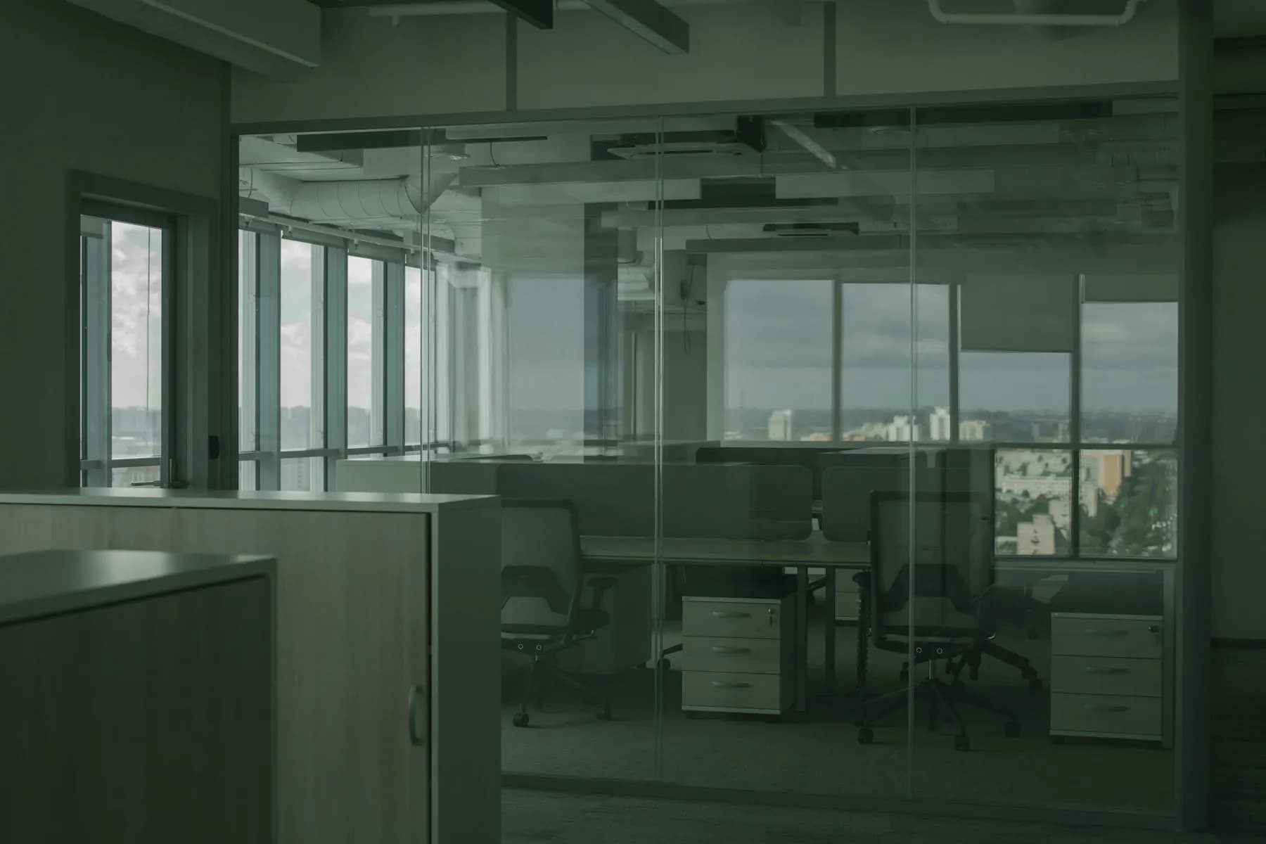 Modern office interior with freshly painted walls and large windows.