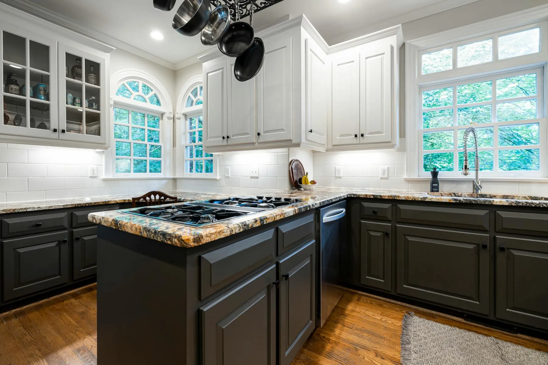 Bright kitchen with white cabinets, granite counters, and a clean residential finish.