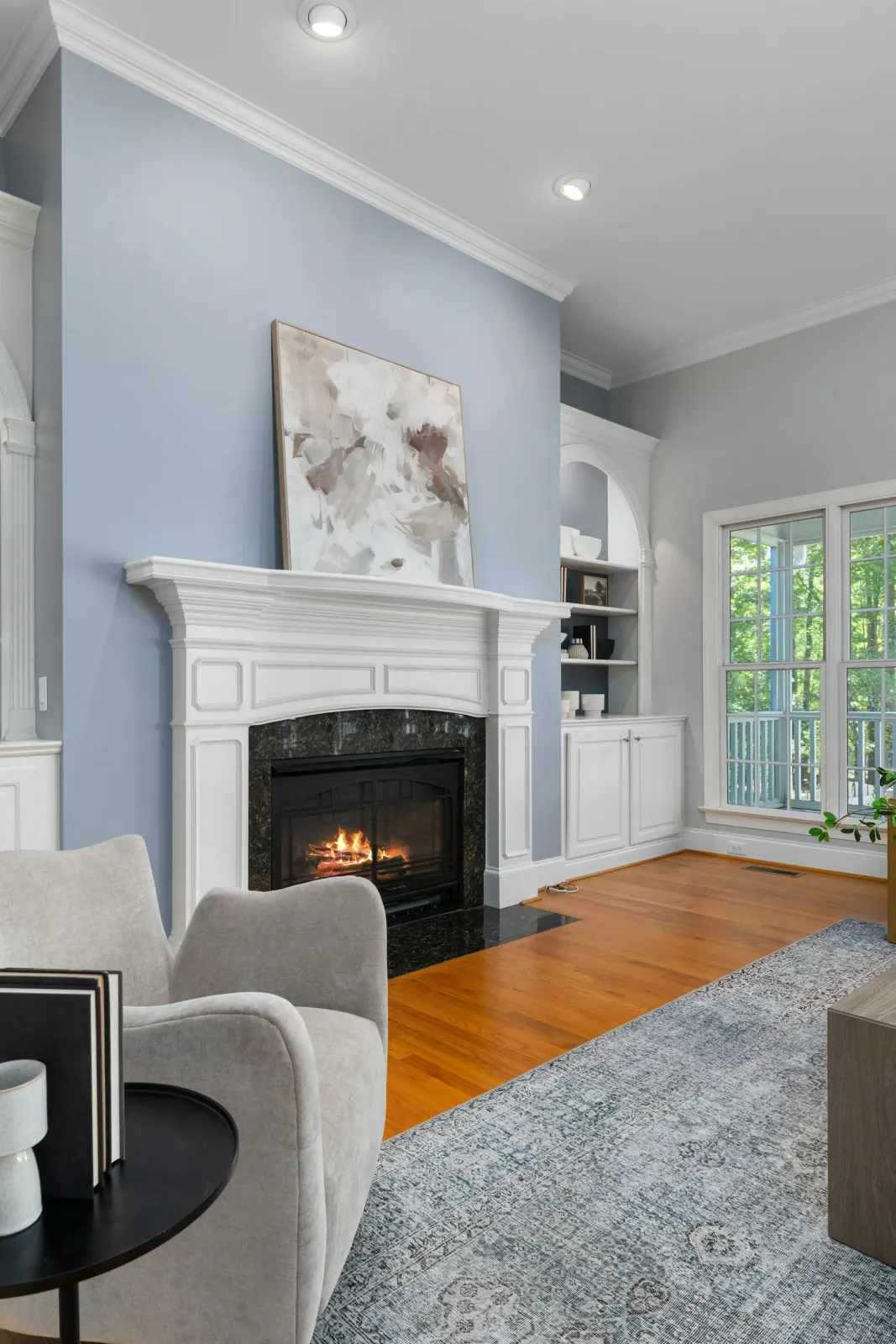 Elegant living room with fireplace, layered textures, and a polished designer finish.