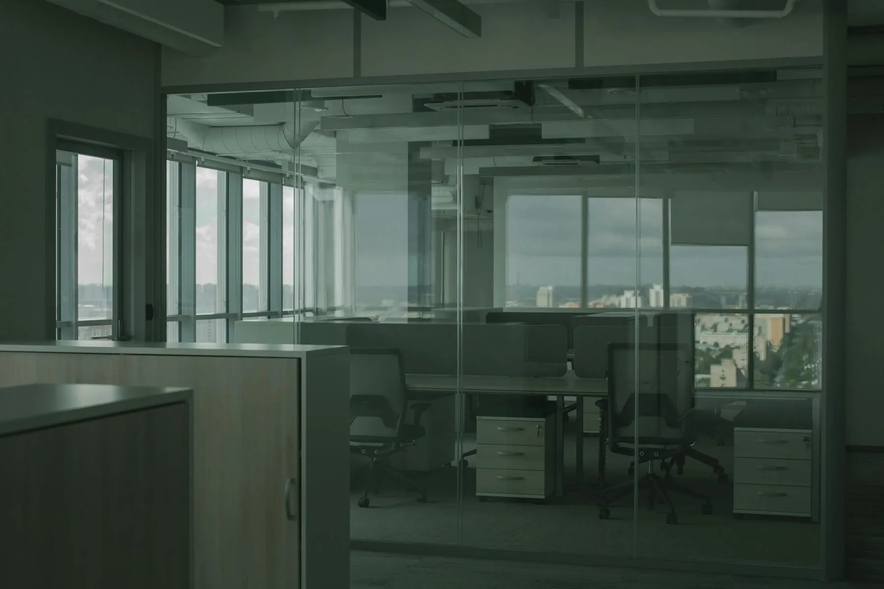 Modern office interior with freshly painted walls and large windows.