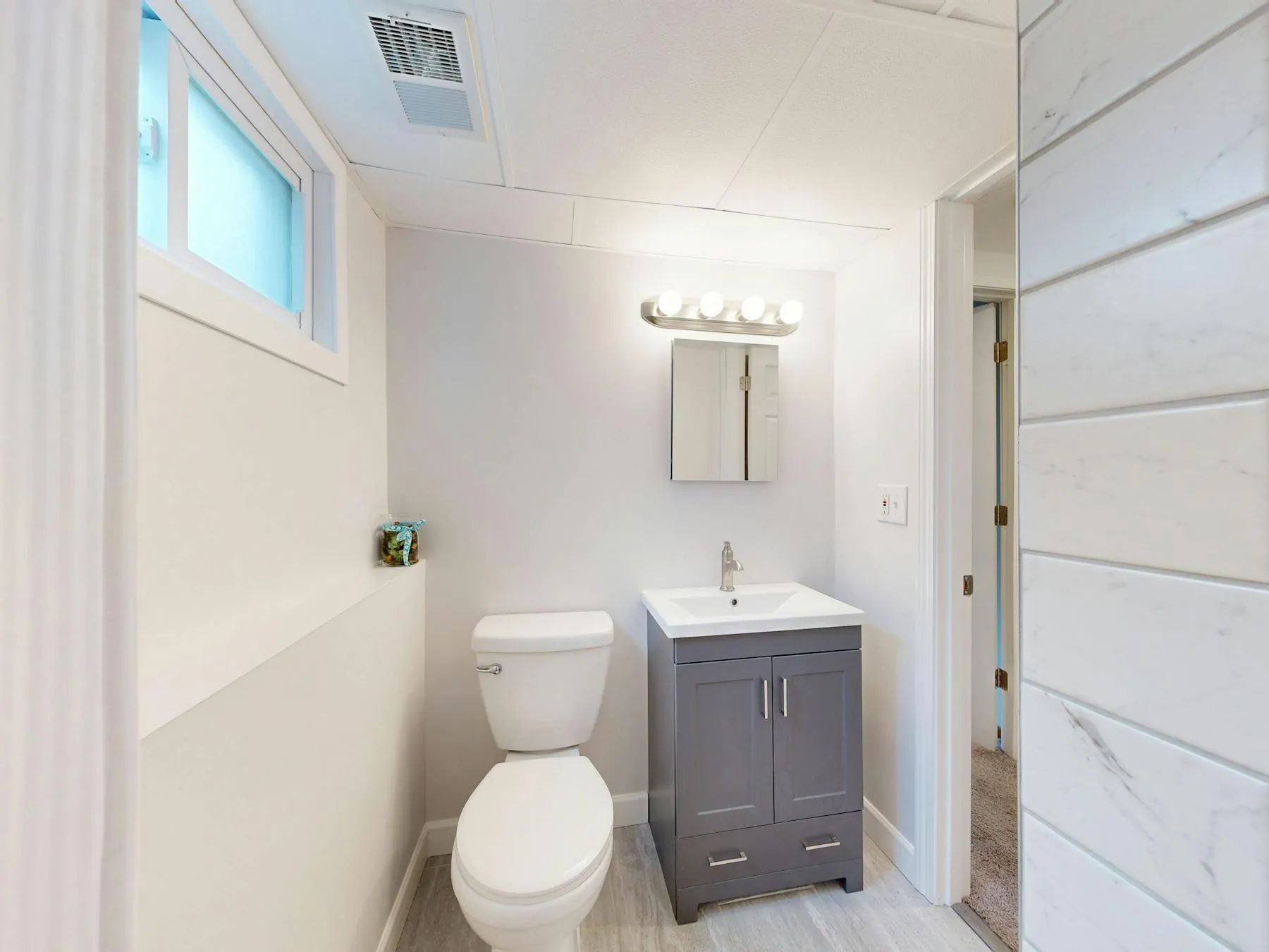 Bright bathroom with freshly painted walls and trim.