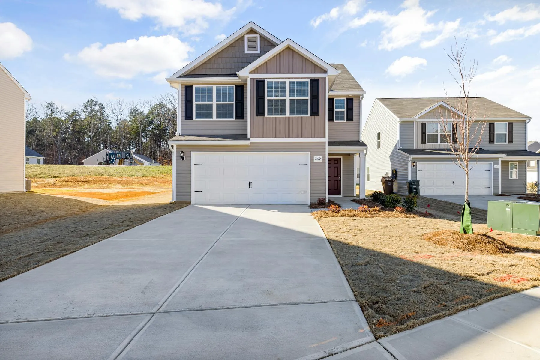 Wide suburban driveway and front approach with a clean, refreshed surface.