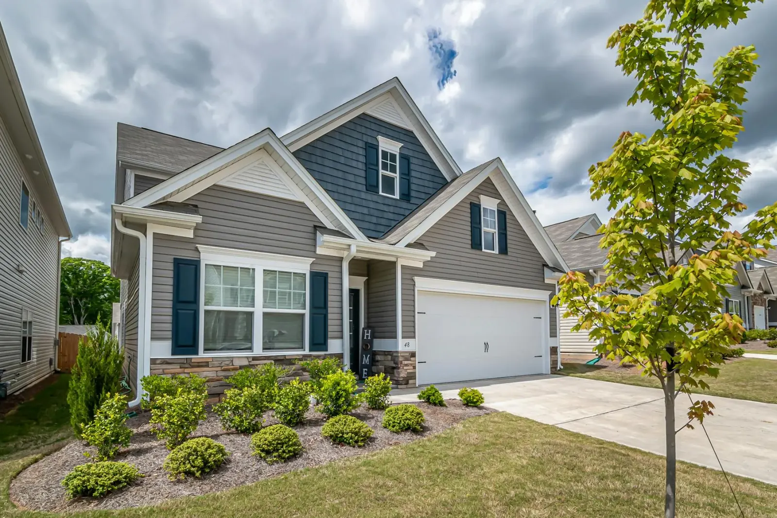 Suburban home exterior with refreshed siding, clean trim, and crisp curb presence.