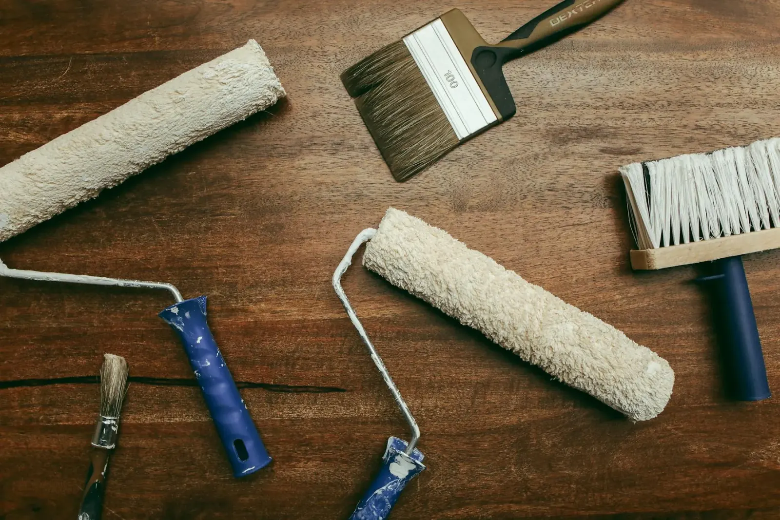 Prepared paint workspace with neatly arranged tools and drop cloths.